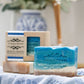 Mellow Monkey Beach Haven handmade bar soap, tropical fruit and coconut scent, blue ocean waves and sand design.