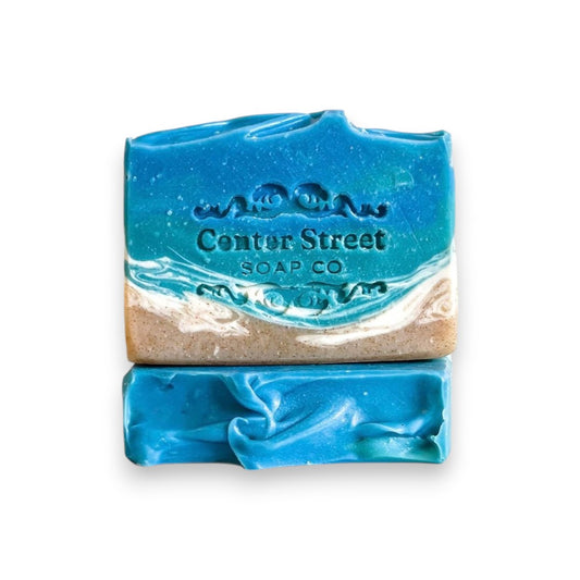 Mellow Monkey Beach Haven Summer handmade soap bar with blue ocean waves and sandy beach design. 4-oz.