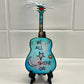 Mellow Monkey Beatles We All Shine On hand-painted wooden guitar ornament with resin finish on a black display easel.