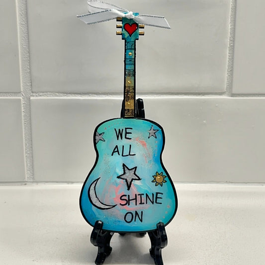 Mellow Monkey Beatles We All Shine On hand-painted wooden guitar ornament with resin finish on a black display easel.