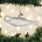 Mellow Monkey white blown glass beluga whale ornament with glitter accents, 5.5 inches, hanging on a Christmas tree.