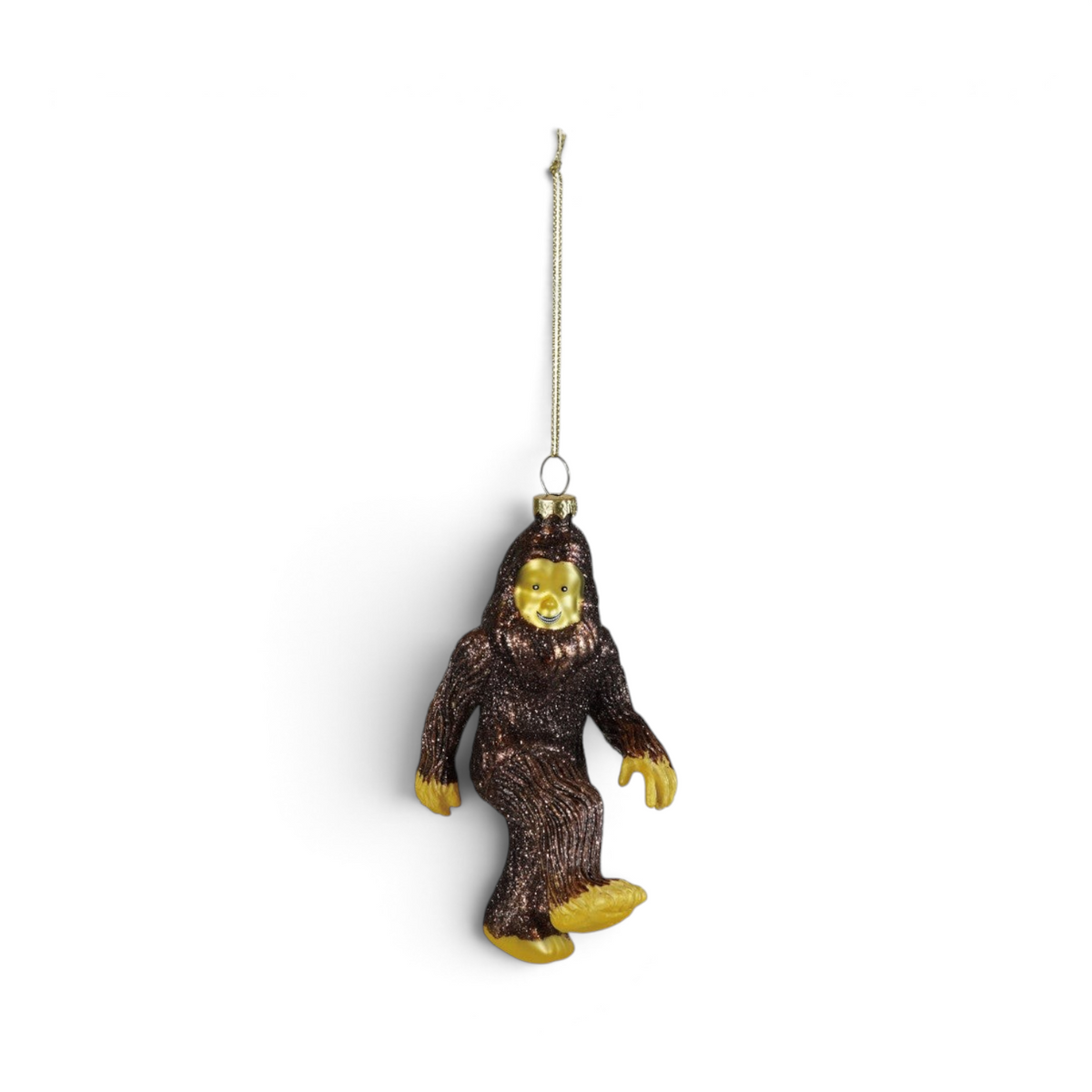 Mellow Monkey hand-painted glass Bigfoot ornament in brown and gold with sparkling glitter accents.