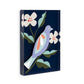 Mellow Monkey Rest Together Tile Acrylic Wall Art, 5x7-in, featuring a lavender bird on a dark blue background with white flowers and green leaves.