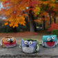 Mellow Monkey set of 3 whimsical poly-resin bird planters in yellow, periwinkle, and turquoise with hand-painted details.