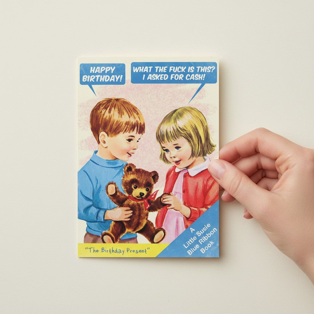 Mellow Monkey birthday card featuring a boy giving a teddy bear to a girl, with text bubbles saying "Happy Birthday!" and "What the fuck is this? I asked for cash!"