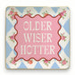 Mellow Monkey ceramic trinket tray with "Older Wiser Hotter" text, pink center, floral accents, and blue diamond pattern.