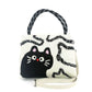 Mellow Monkey black and white polyester cat shoulder bag with top handles and an adjustable crossbody strap.