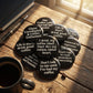 Mellow Monkey 1.25-inch round black pin-back buttons with white coffee-themed quotes on a rustic wooden desk.