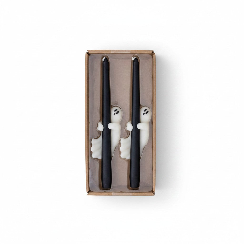 Mellow Monkey set of two unscented black taper candles featuring white ghost decorations in a cardboard gift box