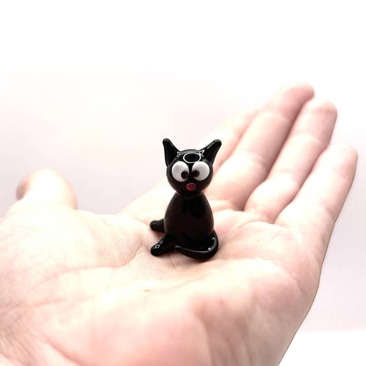Mellow Monkey handblown black glass mini cat figurine with whimsical eyes held in a palm