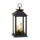 Mellow Monkey 12-inch black lantern with three flameless LED candles, pine greenery, and red berries for holiday decor.