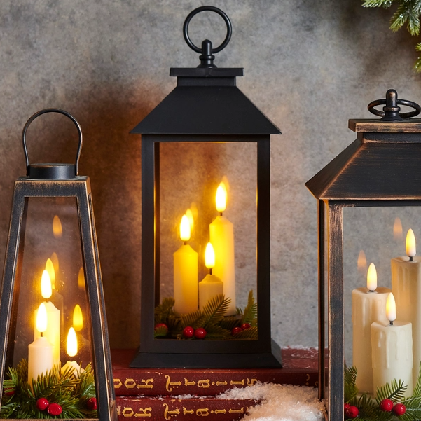 Mellow Monkey 12-inch black lantern with flameless candles, pine greenery, and red berries for holiday decor.