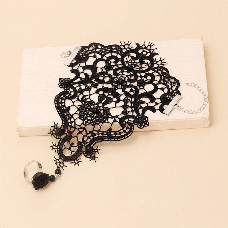 Mellow Monkey black lace fingerless ring-bracelet with intricate vintage-inspired floral patterns and bead accents.