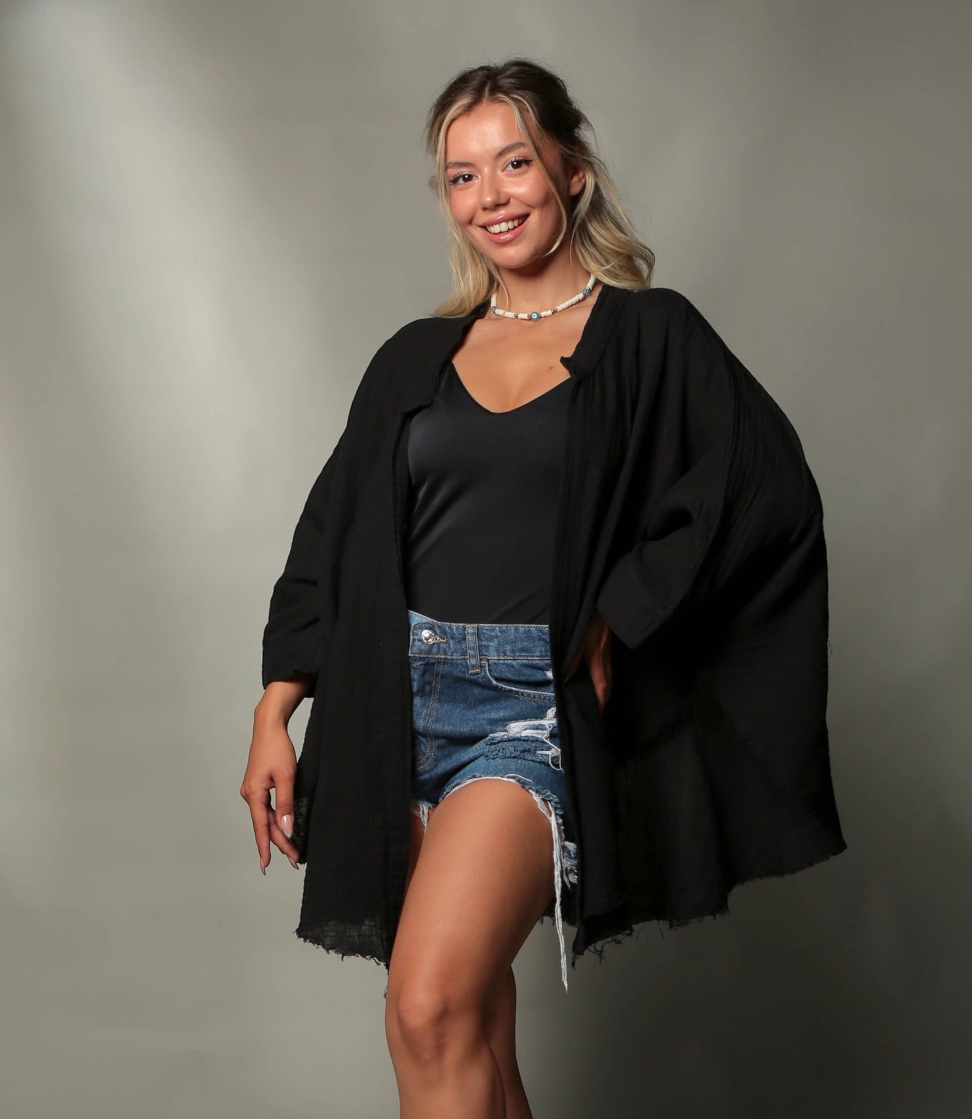 Mellow Monkey black 4-layer muslin kimono robe with golden moon phases on back, worn by a woman with denim shorts.