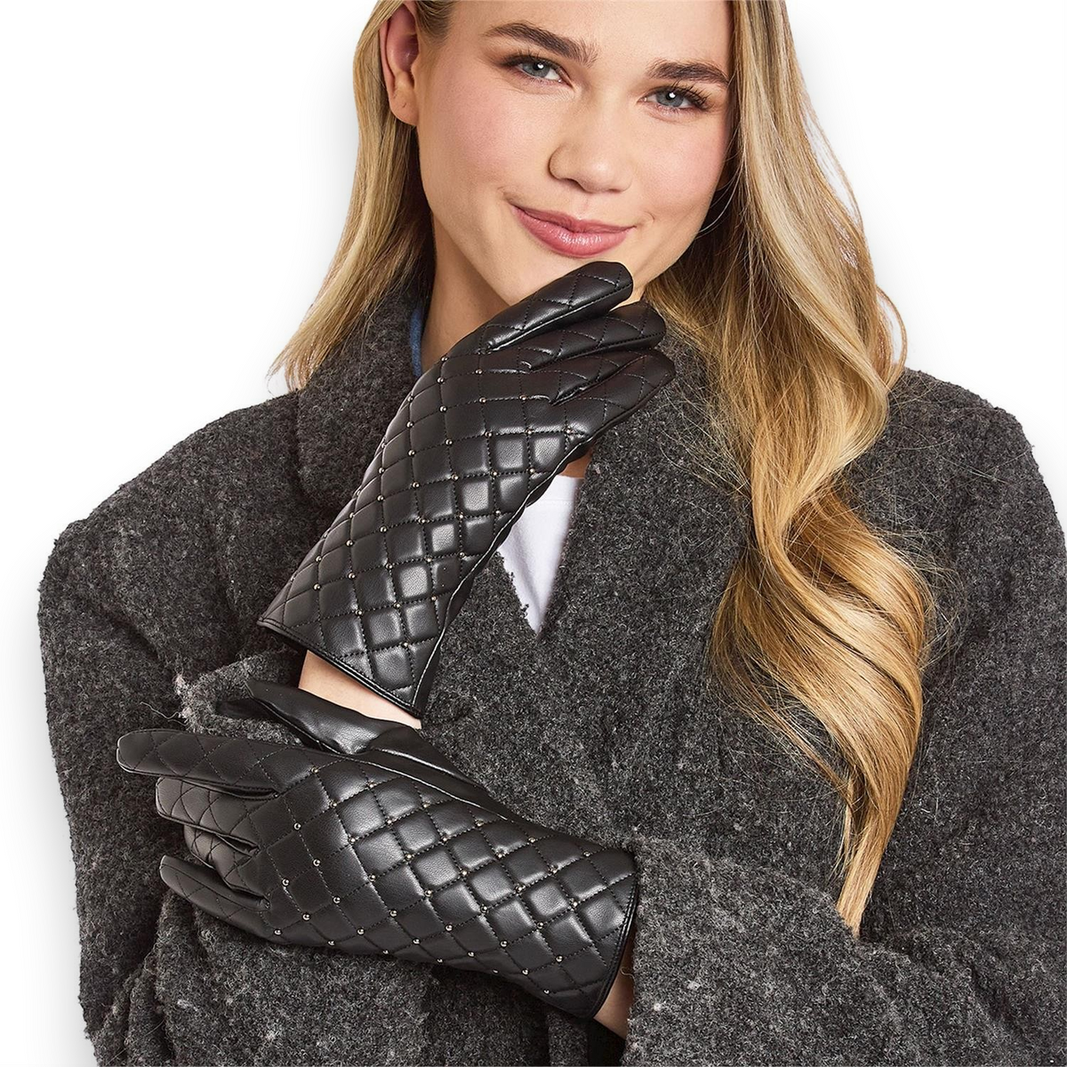 Mellow Monkey black quilted vegan leather gloves with stud detailing worn by a smiling woman in a grey coat