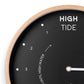 Mellow Monkey 12-inch black tide clock with natural beech frame, white hands, and mineral glass face. Displays high tide and hours until high water.