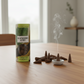 Mellow Monkey blackberry and bay scented incense cones with a small round ceramic holder on a wooden table