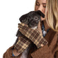 Mellow Monkey Blair tan plaid winter gloves with microsuede palms worn by a woman holding a small black puppy.