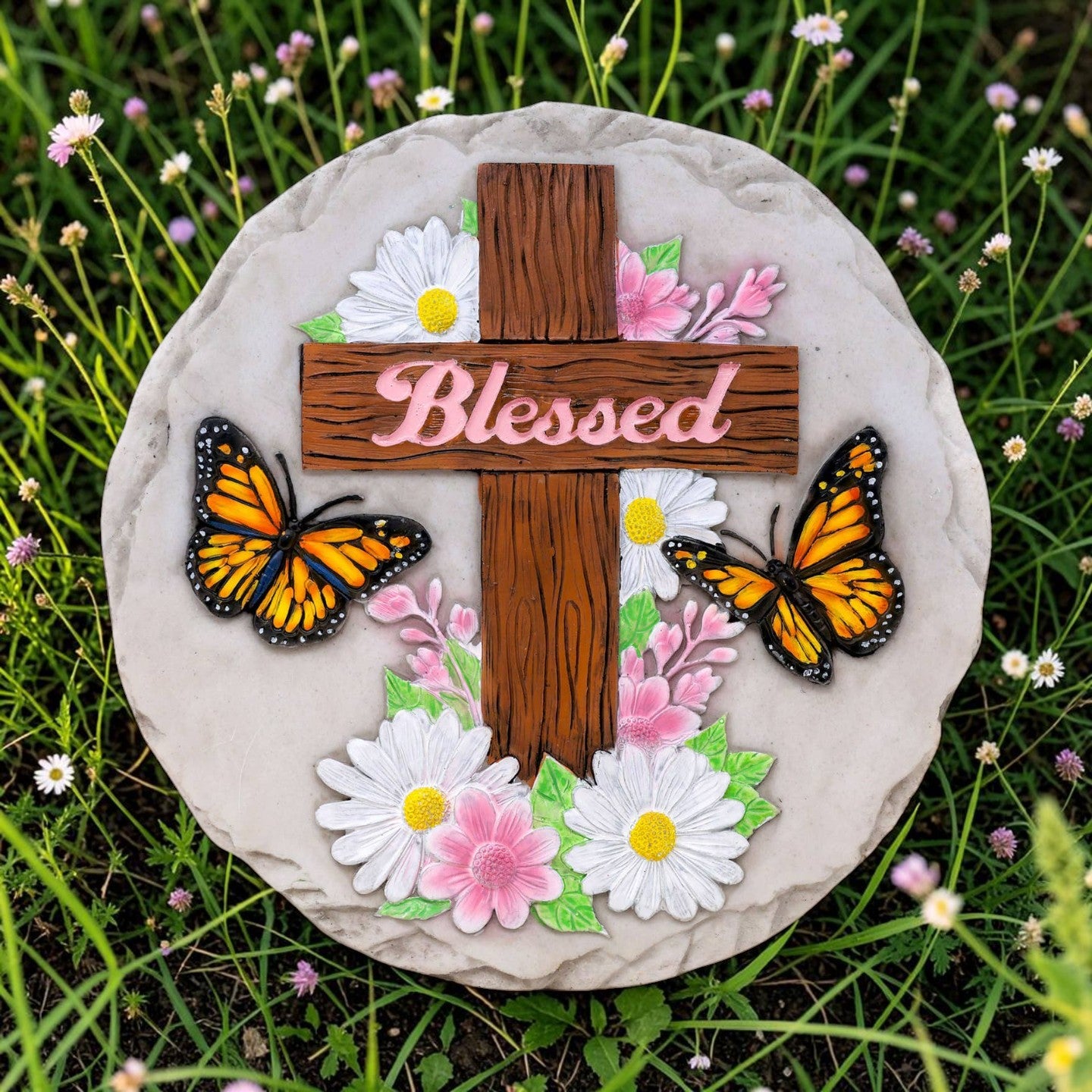 Mellow Monkey Blessed stepping stone featuring a wooden cross, monarch butterflies, and flowers on a round stone base.