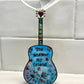 Mellow Monkey Blowing In The Wind guitar ornament with blue hand-painted finish, dandelion art, and heart accents.