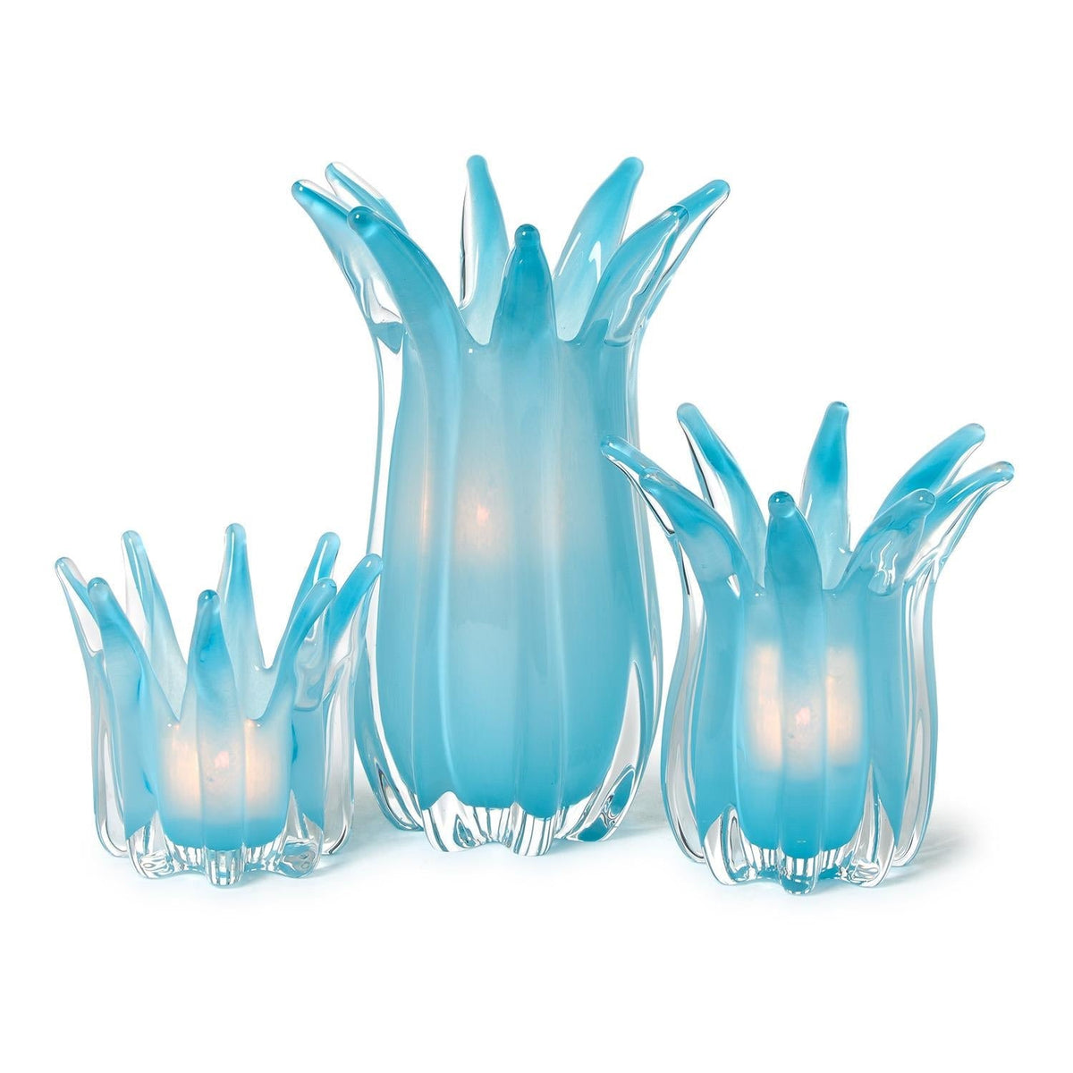 Mellow Monkey set of 3 hand-blown blue art glass candle holders or vases with delicate white petal-like edges.