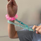 Mellow Monkey Blue Blast Feelzies sensory bracelet with glittery blue squishy material being stretched on a wrist