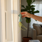 Mellow Monkey blue ceramic squid hanging planter with a live Tillandsia air plant held by a hand near a window