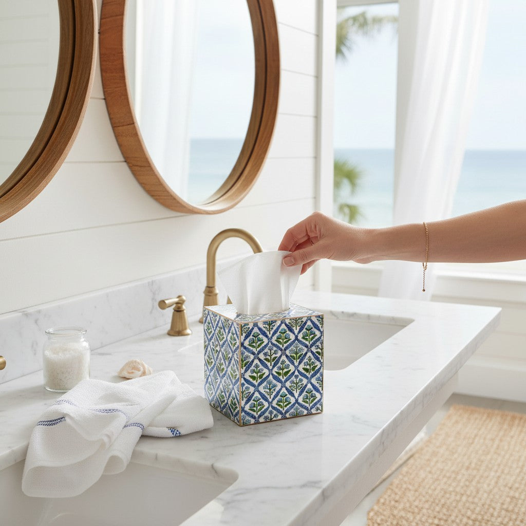 Mellow Monkey blue floral block print paper mache tissue box cover with gold painted edges on a bathroom vanity.