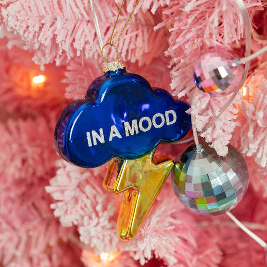 Mellow Monkey deep blue glass cloud ornament with a gold lightning bolt and In A Mood text on a pink Christmas tree.