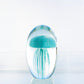 Mellow Monkey blue glass jellyfish paperweight with detailed tentacles inside a clear rounded glass dome