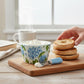 Mellow Monkey Blue Hydrangea ceramic bowl and spreader set with a blue and white patterned handle.