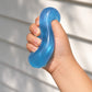 Mellow Monkey blue jelly donut sensory fidget being squeezed in a hand to show its soft, squishy, and stretchy texture.