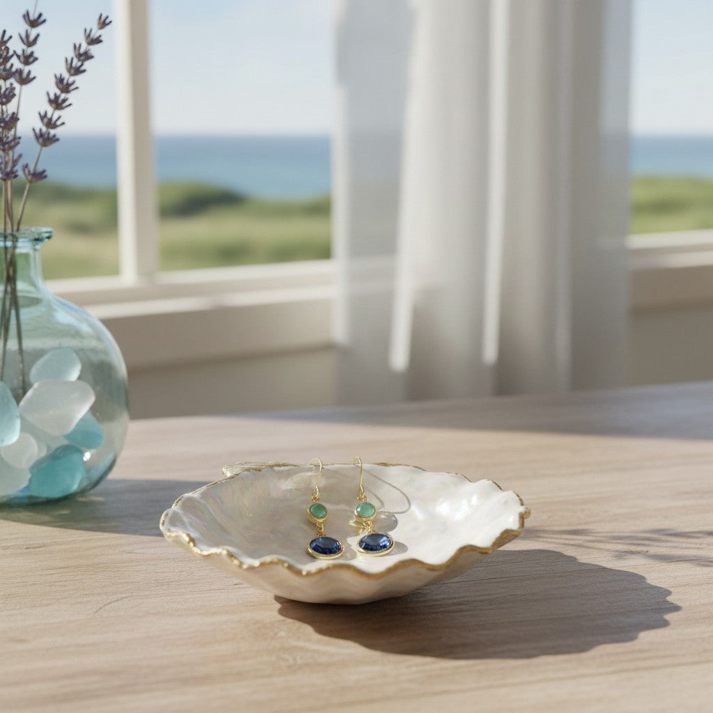 Mellow Monkey blue and mint crystal dangle earrings in a decorative shell dish by a sunny coastal window.