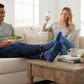 Mellow Monkey blue crew socks with green and light blue stripes worn by a man relaxing on a couch with a salad