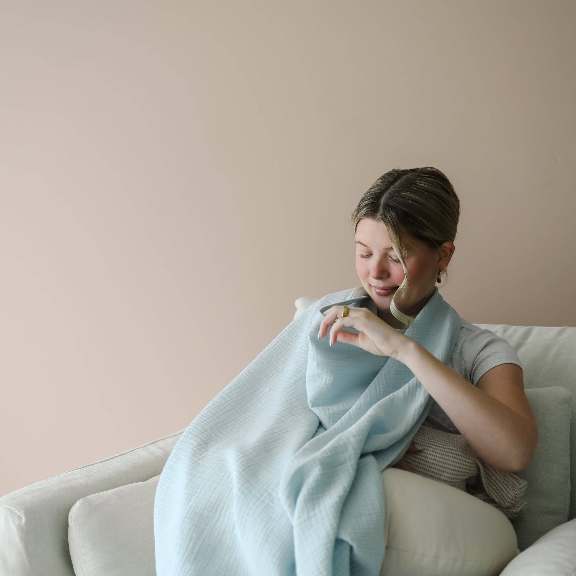 Mellow Monkey Bluebell nursing cover in soft light blue organic cotton muslin with a built-in silicone teether.