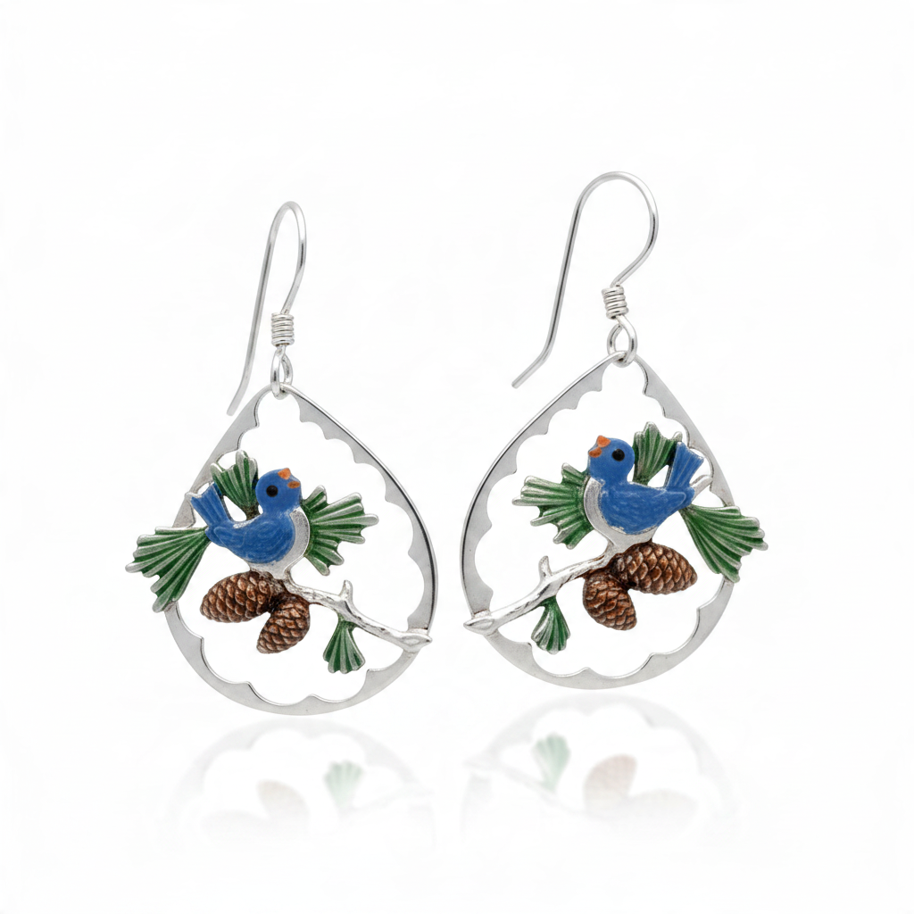 Mellow Monkey silver teardrop earrings featuring a bluebird on a branch with acorns and green needles