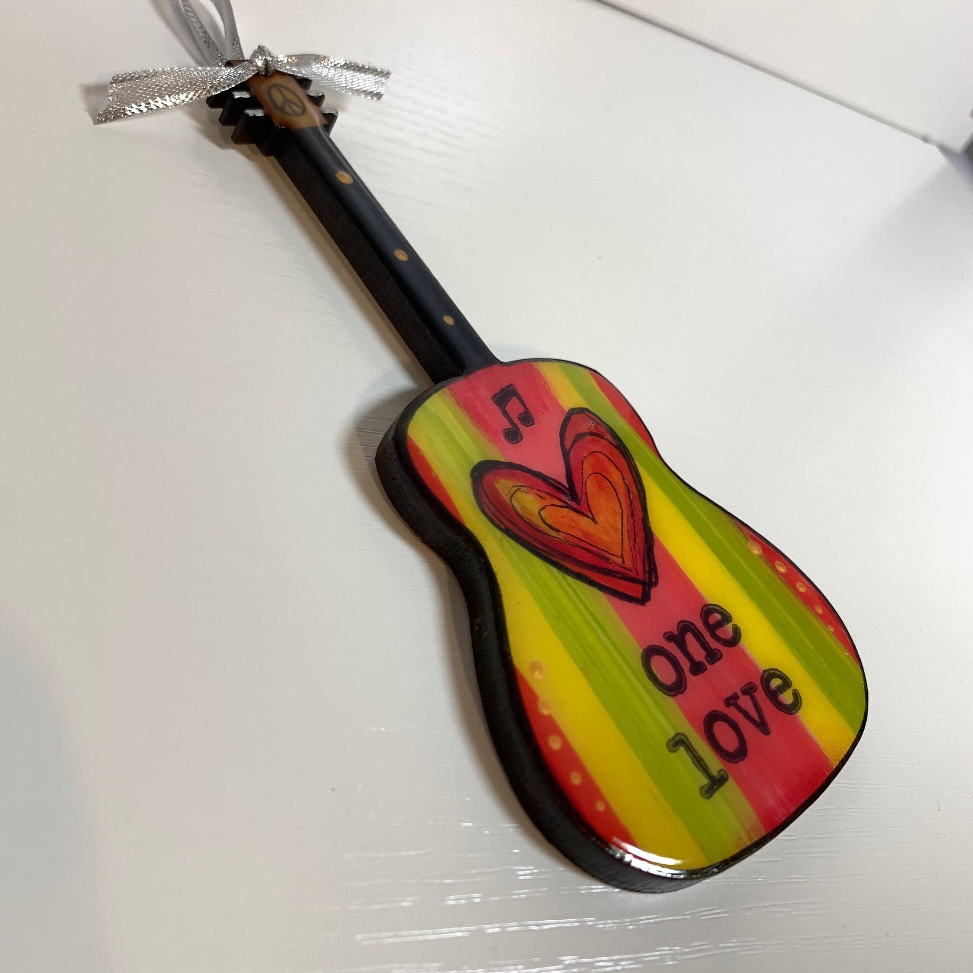 Mellow Monkey Bob Marley One Love guitar ornament in Rasta colours with a heart design and silver ribbon hanger.
