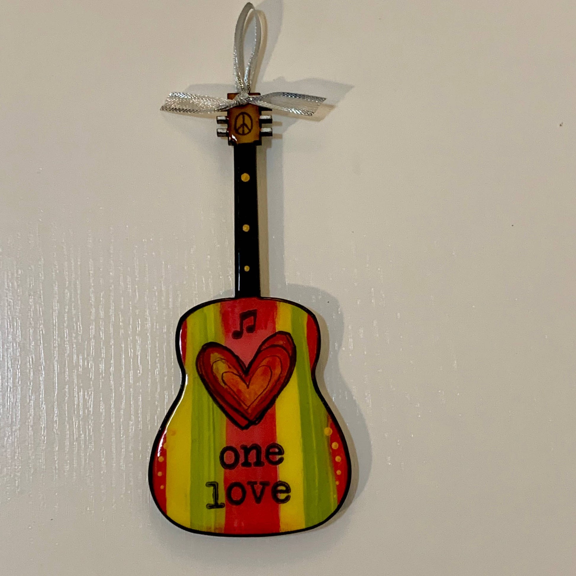 Mellow Monkey Bob Marley One Love guitar ornament with red, yellow, and green stripes and a heart design.