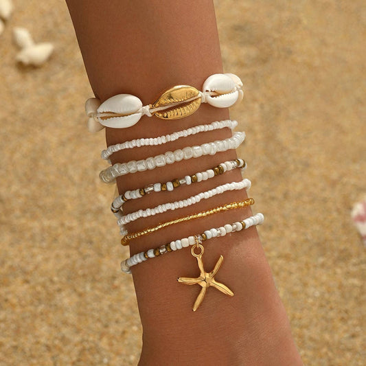Mellow Monkey bohemian beach bracelet set featuring white beads, seashell accents, and a gold starfish charm.