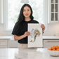 Mellow Monkey boho mermaid flour sack cotton kitchen towel held by a woman in a bright kitchen