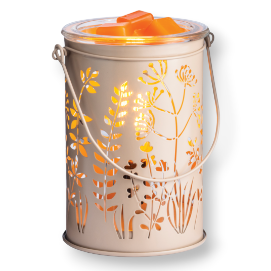 Mellow Monkey Botanical Glow metal fragrance warmer with floral cutouts and orange wax melts glowing in a rustic style