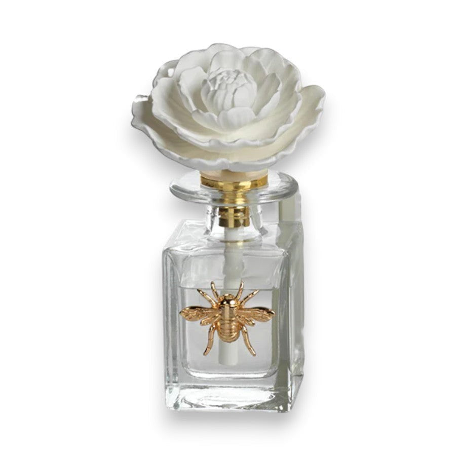 Mellow Monkey Apothecary Guild Botanical Oasis diffuser with white flower top and gold bee accent. Black Fig Vetiver scent.