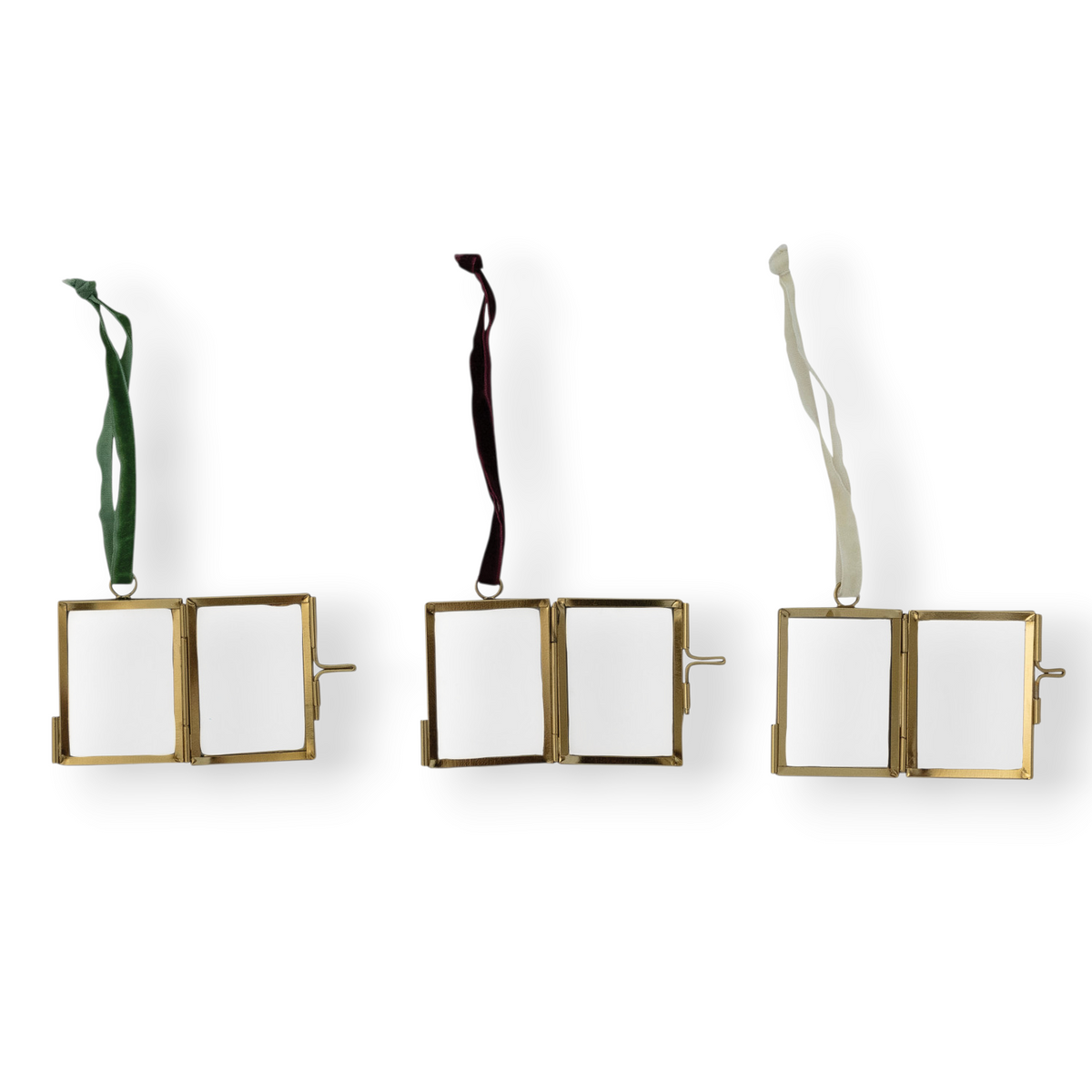 Mellow Monkey brass and glass miniature photo frame ornaments with red, green, and white velvet ribbon hangers.