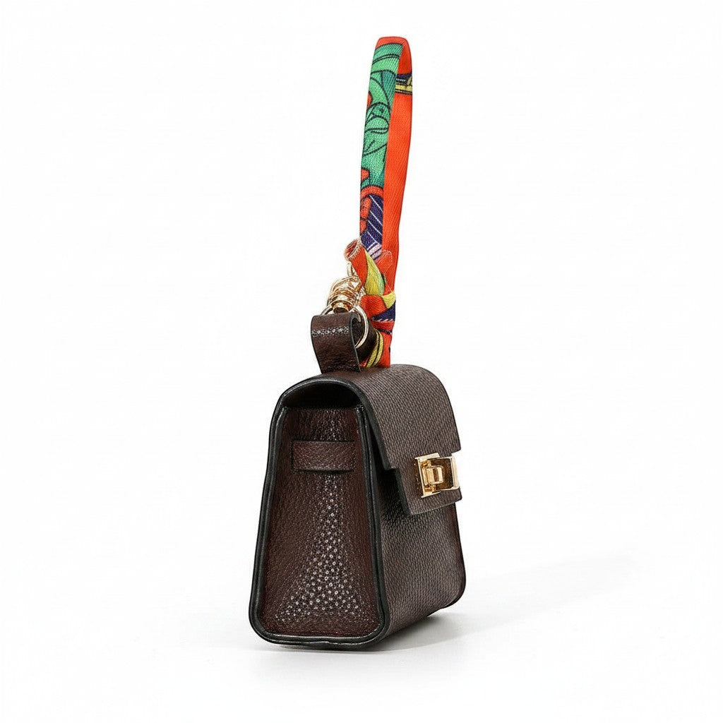 Mellow Monkey brown faux leather mini handbag keychain with colorful scarf detail and gold clasp.