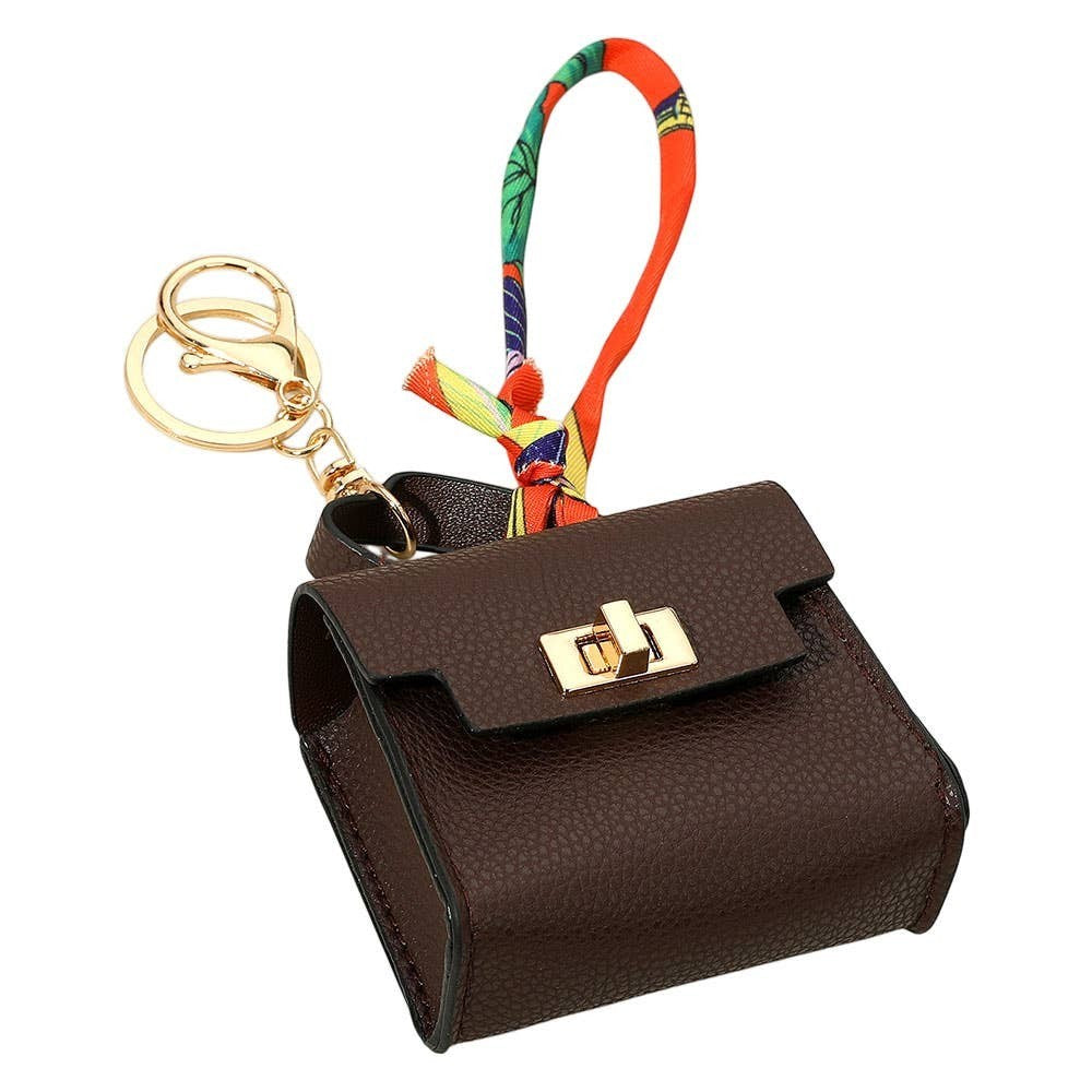 Mellow Monkey brown faux leather mini handbag keychain with gold clasp and colorful scarf accent.