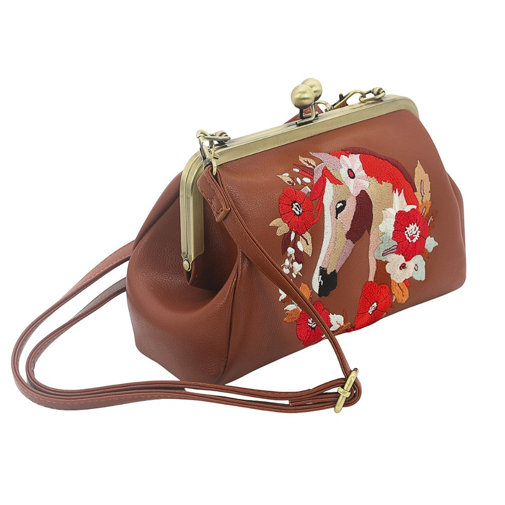 Mellow Monkey brown vinyl kisslock bag featuring an embroidered horse and floral wreath design with a crossbody strap.
