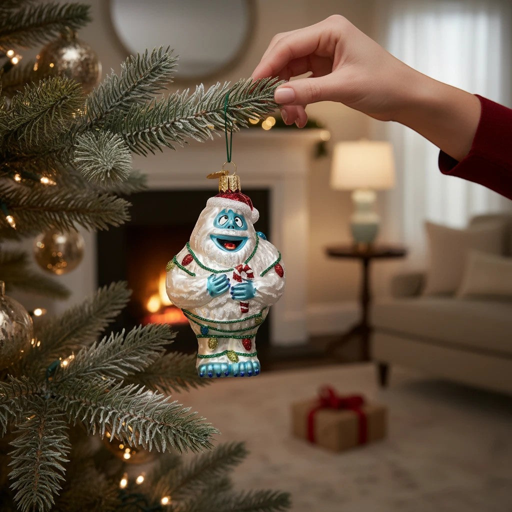 Mellow Monkey Bumble the Abominable Snow Monster Christmas ornament, 4.5-in blown glass, holding candy cane, wrapped in lights.