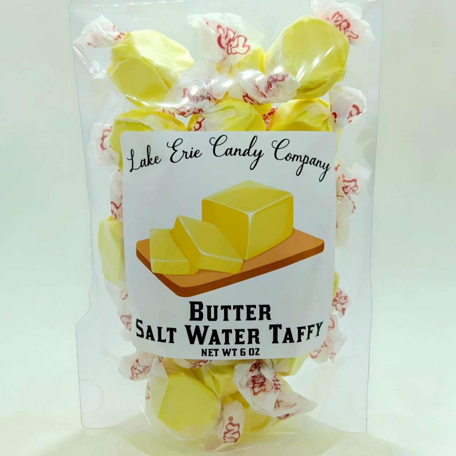 Mellow Monkey Butter Salt Water Taffy, individually wrapped yellow candies with a rich, buttery flavor and chewy texture.