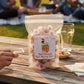 Mellow Monkey Butterbeer Salt Water Taffy bag on a picnic table with people in the background.