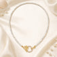 Mellow Monkey 18K gold plated choker with mother of pearl beads and a butterfly clasp with cubic zirconia.